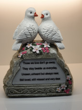 Two doves sitting on a rock 